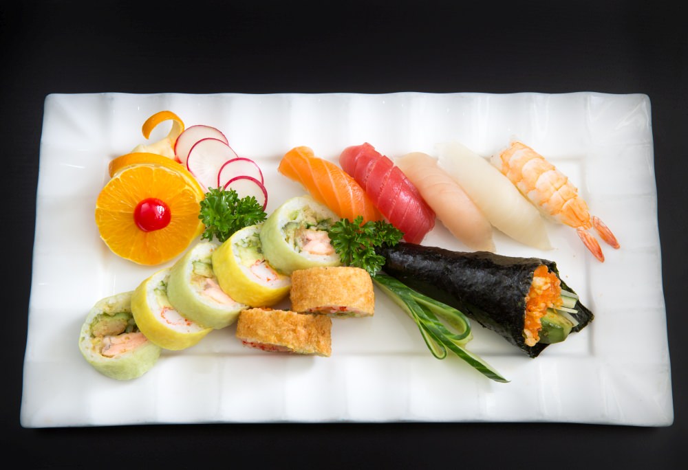 Temaki hand roll cone served alongside nigiri on a white platter at Aikawa Japanese Restaurant in West Island Montreal